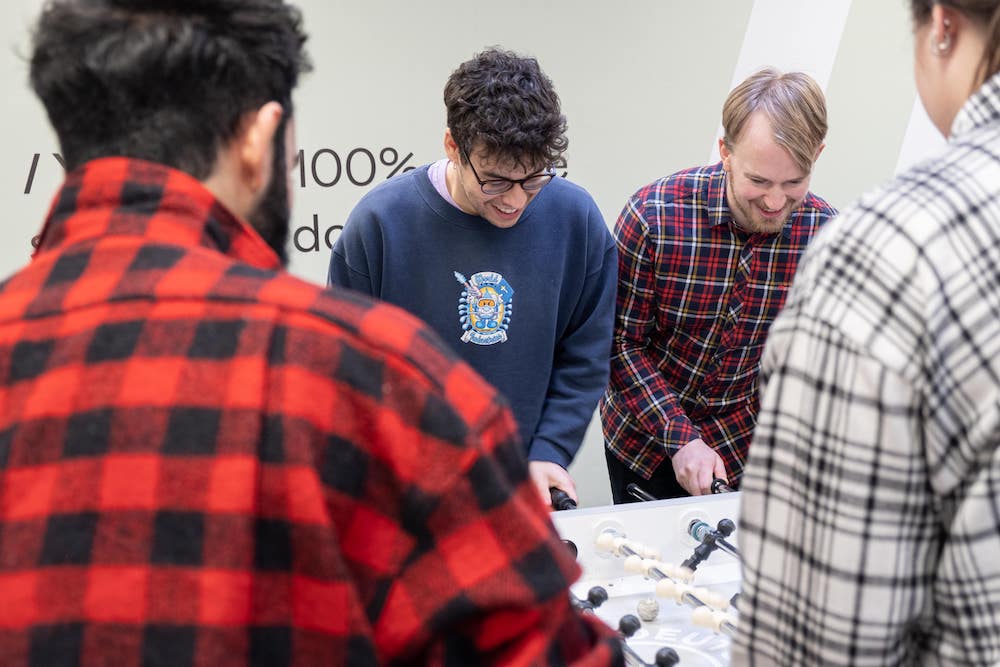 Four Innovattic employees playing foosball